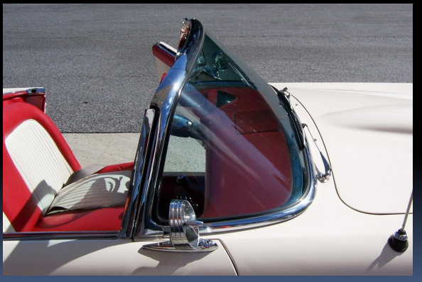Photo of vintage convertible automobile curved glass windshield